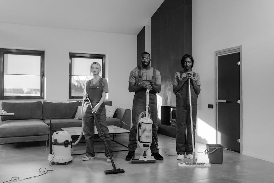 A person is kneeling on a patterned carpet, loading a white cloth into the open yellow and black vacuum cleaner of Carpet Cleaners Kentish Town, practicing surface cleaning. The vacuum cleaner's hose is connected to the device, and the room appears well-lit with warm lighting. The visible area includes a section of the carpet, highlighting the process of deep carpet cleaning aimed at hygiene and maintenance, aligned with the services described on the page titled 'Avoid hidden charges in Kentish Town carpet cleaning quotes, KENTISH TOWN'. The scene emphasizes routine domestic cleaning tasks, focusing on ensuring cleanliness and hygiene of interior surfaces.